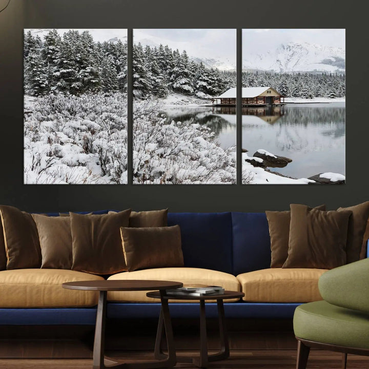 Experience the beauty of winter with the "Cabin by the Lake Canvas Wall Art," showcasing a serene snowy landscape. This rustic nature decor features a cozy cabin nestled amid snow-laden trees, set against a breathtaking mountain view, perfect for enhancing your living room.