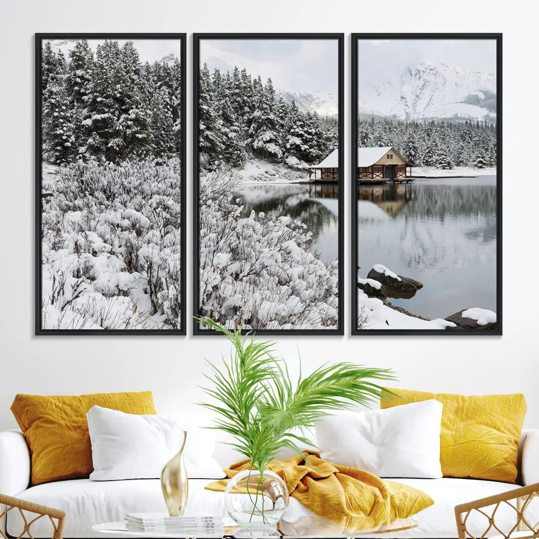 Experience the beauty of winter with the "Cabin by the Lake Canvas Wall Art," showcasing a serene snowy landscape. This rustic nature decor features a cozy cabin nestled amid snow-laden trees, set against a breathtaking mountain view, perfect for enhancing your living room.