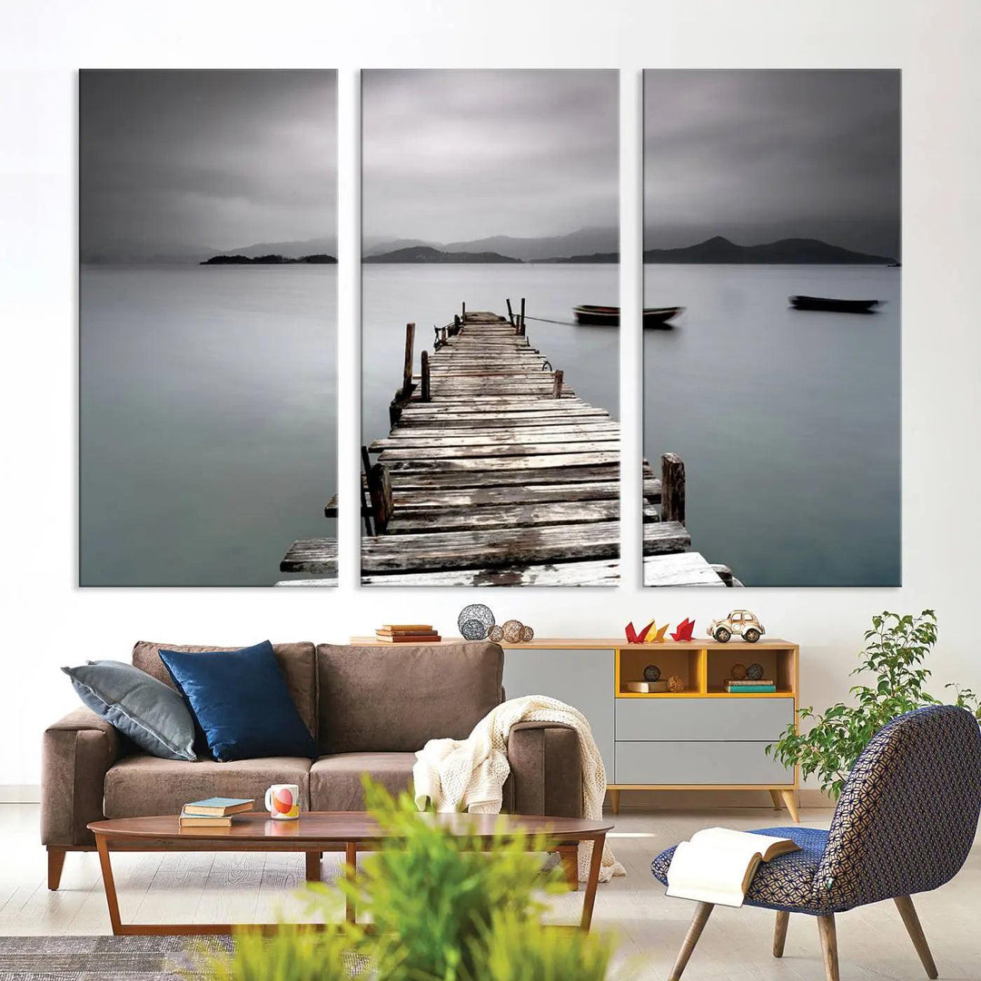 A serene triptych featuring a wooden pier stretching into misty waters brings the Wooden Pier Canvas Wall Art Beach Canvas Artwork Print to life.