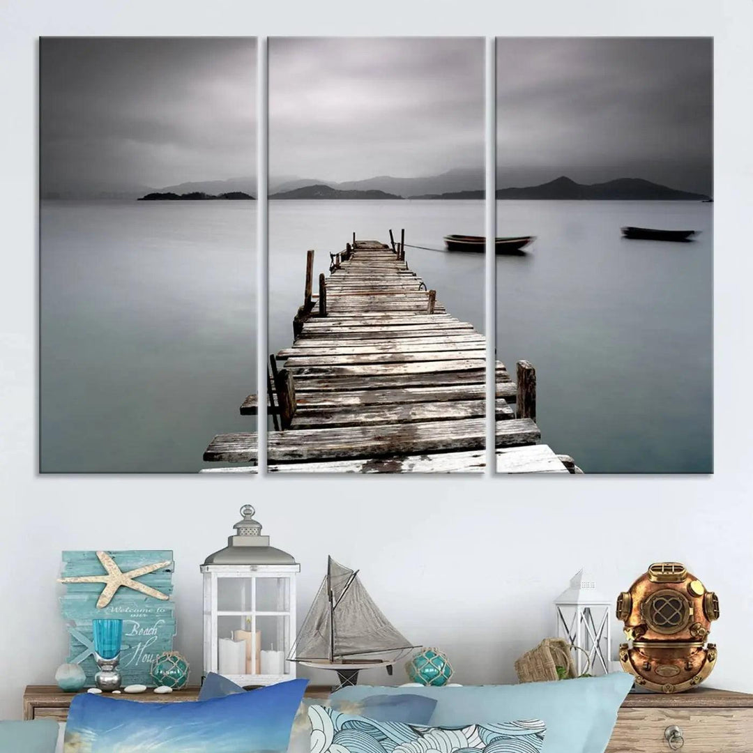 A serene triptych featuring a wooden pier stretching into misty waters brings the Wooden Pier Canvas Wall Art Beach Canvas Artwork Print to life.