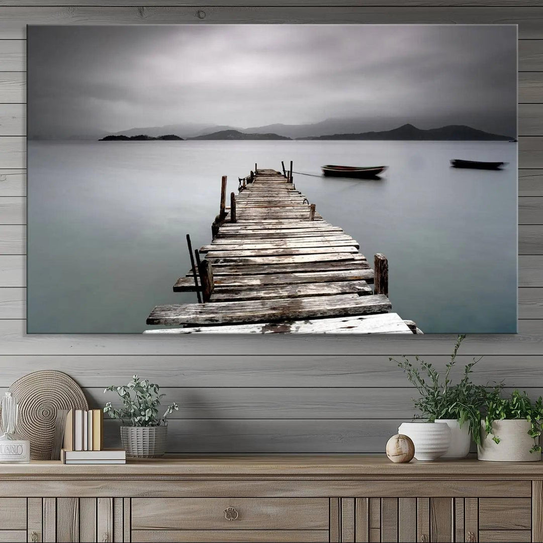 A serene triptych featuring a wooden pier stretching into misty waters brings the Wooden Pier Canvas Wall Art Beach Canvas Artwork Print to life.