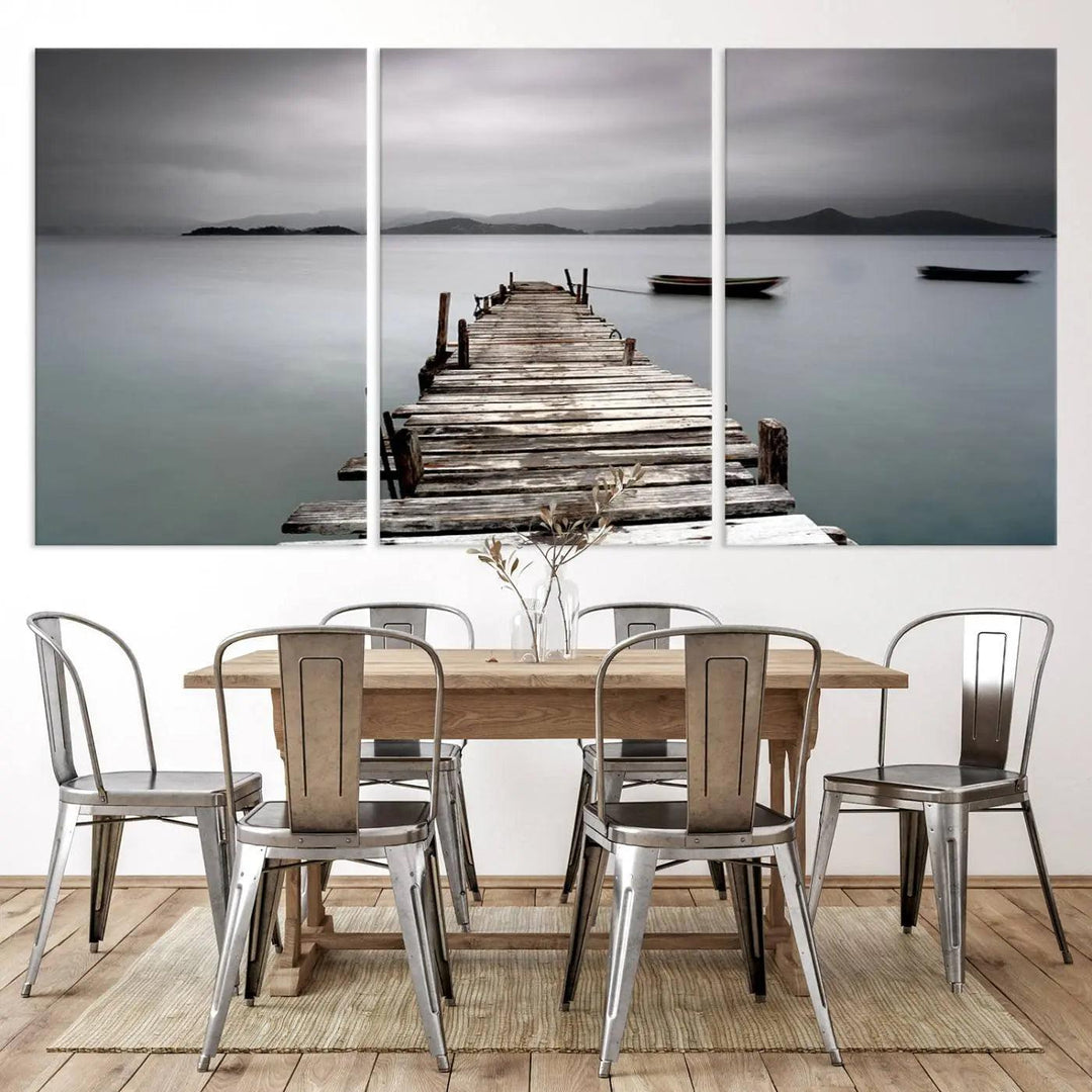 A serene triptych featuring a wooden pier stretching into misty waters brings the Wooden Pier Canvas Wall Art Beach Canvas Artwork Print to life.