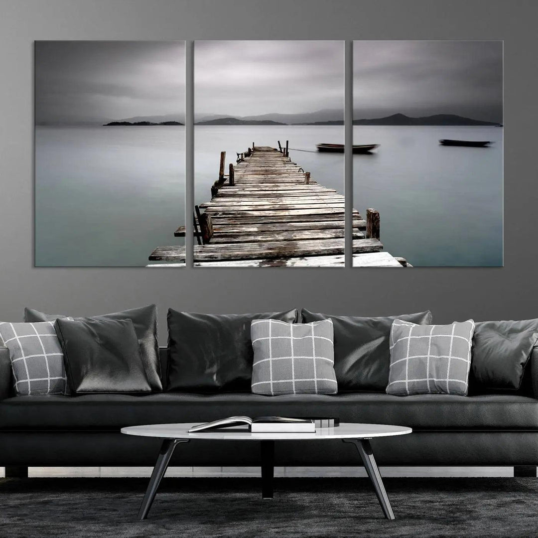 A serene triptych featuring a wooden pier stretching into misty waters brings the Wooden Pier Canvas Wall Art Beach Canvas Artwork Print to life.