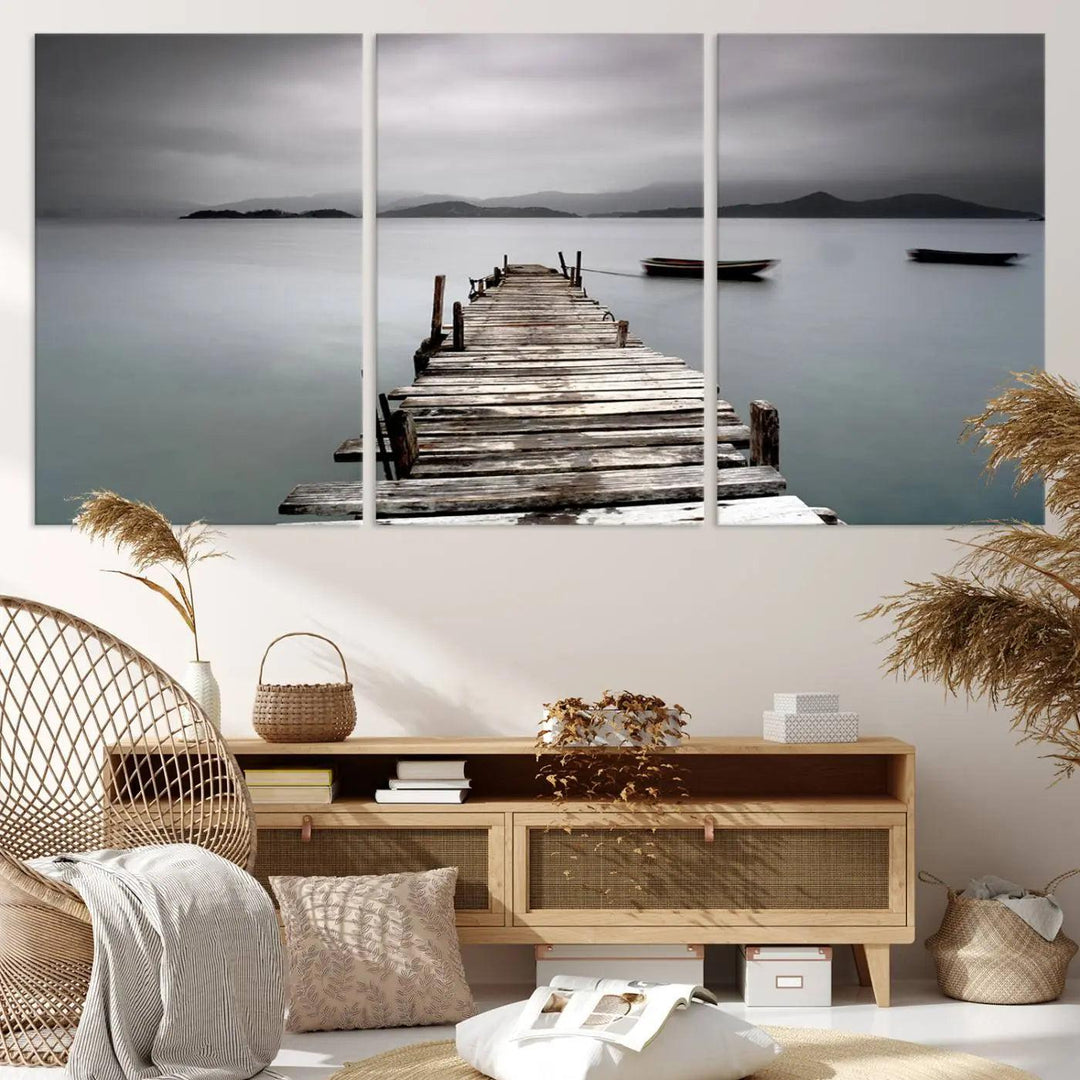 A serene triptych featuring a wooden pier stretching into misty waters brings the Wooden Pier Canvas Wall Art Beach Canvas Artwork Print to life.