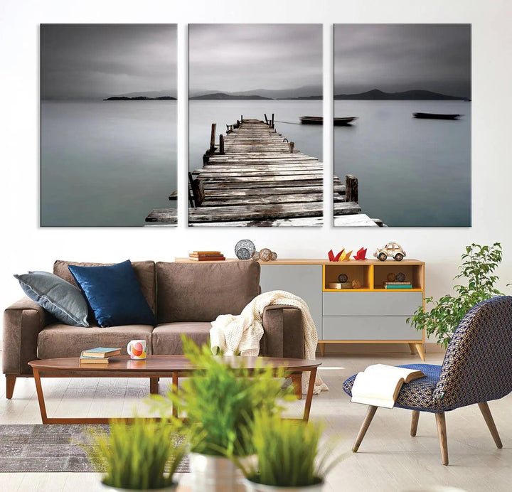 A serene triptych featuring a wooden pier stretching into misty waters brings the Wooden Pier Canvas Wall Art Beach Canvas Artwork Print to life.