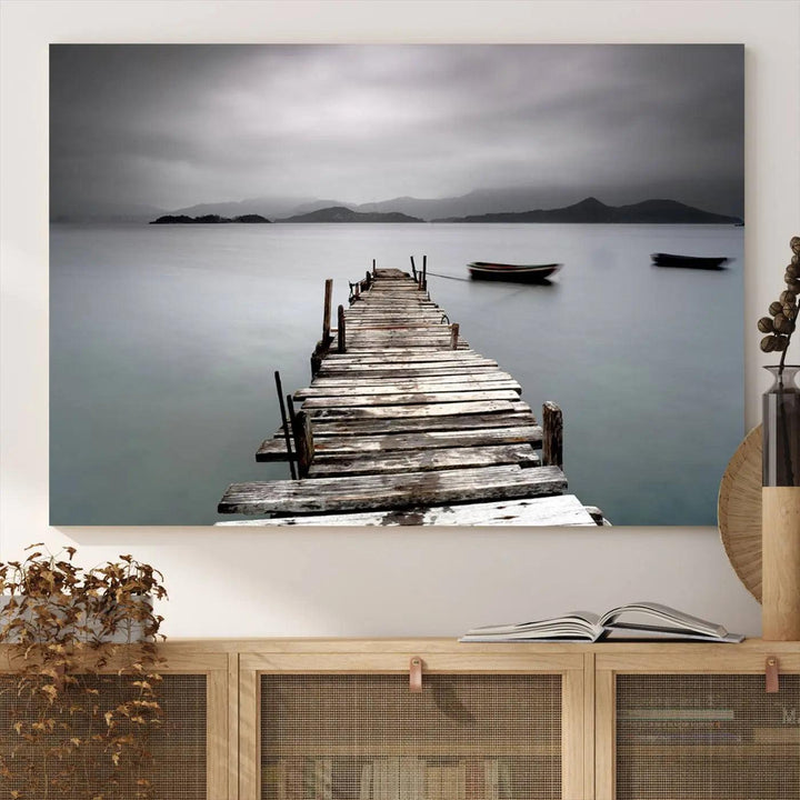 A serene triptych featuring a wooden pier stretching into misty waters brings the Wooden Pier Canvas Wall Art Beach Canvas Artwork Print to life.