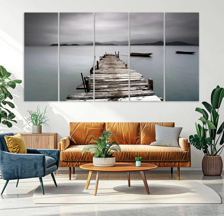 A serene triptych featuring a wooden pier stretching into misty waters brings the Wooden Pier Canvas Wall Art Beach Canvas Artwork Print to life.