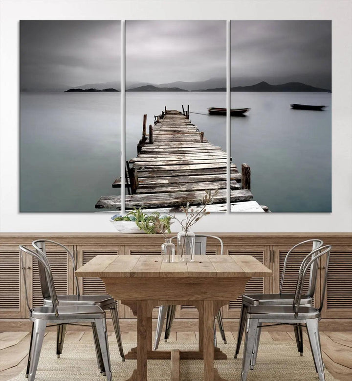 A serene triptych featuring a wooden pier stretching into misty waters brings the Wooden Pier Canvas Wall Art Beach Canvas Artwork Print to life.