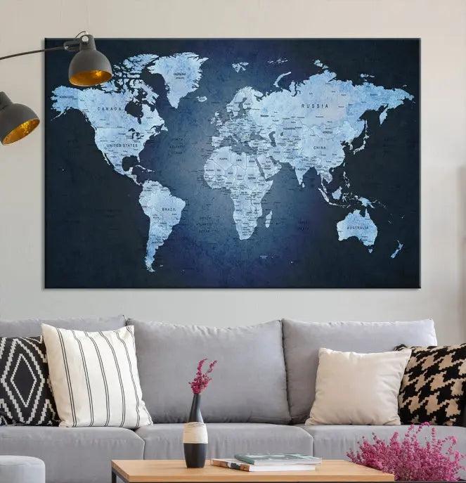 A modern living room featuring a World Map Wall Art Canvas Print in triptych format.