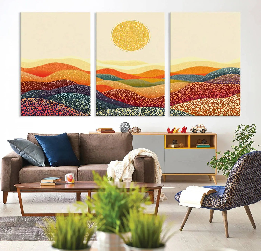 A triptych featuring the YAYOI KUSAMA Colorful Dot Art Landscape Canvas showcases a vibrant abstract pointillism design with rolling hills and a sun. It's mounted on premium canvas and displayed on a dark wall.