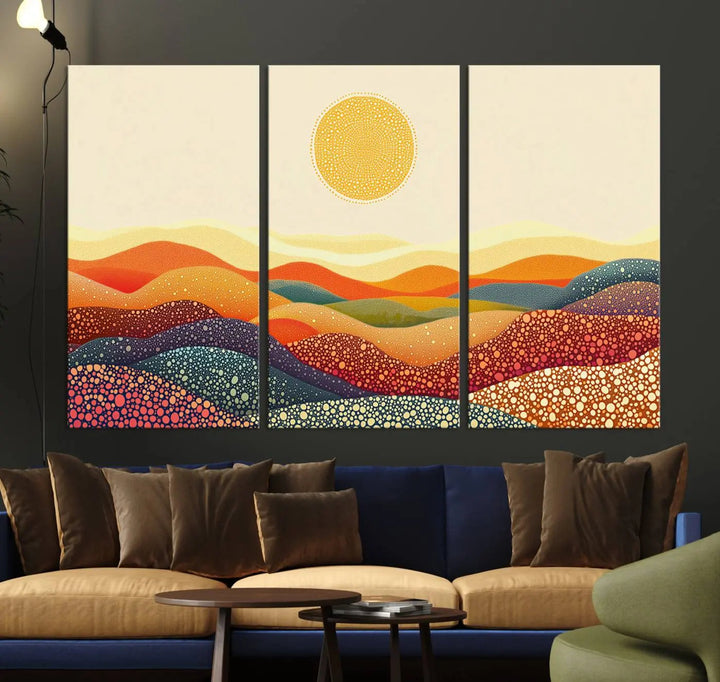 A triptych featuring the YAYOI KUSAMA Colorful Dot Art Landscape Canvas showcases a vibrant abstract pointillism design with rolling hills and a sun. It's mounted on premium canvas and displayed on a dark wall.