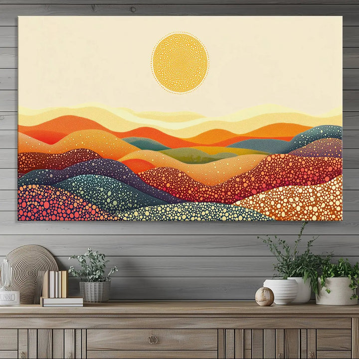 A triptych featuring the YAYOI KUSAMA Colorful Dot Art Landscape Canvas showcases a vibrant abstract pointillism design with rolling hills and a sun. It's mounted on premium canvas and displayed on a dark wall.