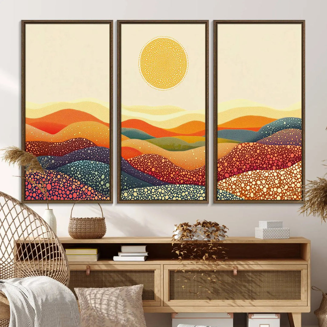 A triptych featuring the YAYOI KUSAMA Colorful Dot Art Landscape Canvas showcases a vibrant abstract pointillism design with rolling hills and a sun. It's mounted on premium canvas and displayed on a dark wall.