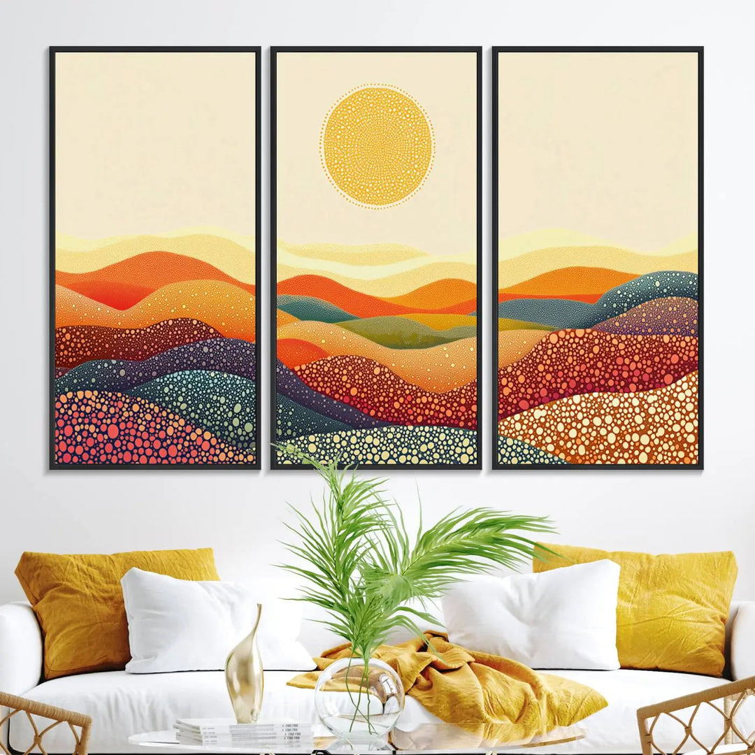 A triptych featuring the YAYOI KUSAMA Colorful Dot Art Landscape Canvas showcases a vibrant abstract pointillism design with rolling hills and a sun. It's mounted on premium canvas and displayed on a dark wall.