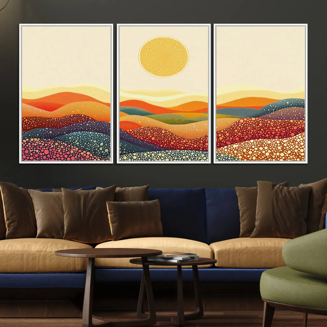 A triptych featuring the YAYOI KUSAMA Colorful Dot Art Landscape Canvas showcases a vibrant abstract pointillism design with rolling hills and a sun. It's mounted on premium canvas and displayed on a dark wall.