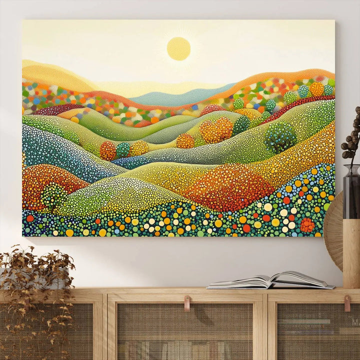 A triptych of the YAYOI KUSAMA Wall Art features a colorful dot art landscape on canvas with vibrant rolling hills and a sun, reminiscent of abstract pointillism inspired by nature.