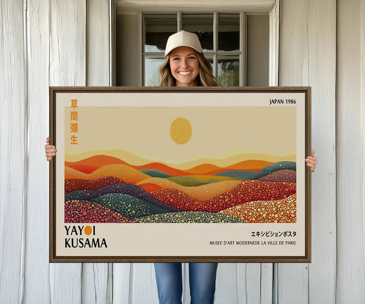 The Yayoi Kusama Wall Art Print is a vibrant abstract landscape canvas featuring colorful dotted hills and a sun, showcasing Japanese art and signed by Yayoi Kusama. It is dated Japan 1986.